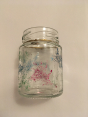 Glasvase mit farbigen Glitzerpflanzen